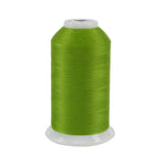 Spool of green thread on a white background
