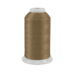 Spool of brown thread on a white background