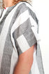 Close-up of a person wearing a white shirt with black geometric patterns.