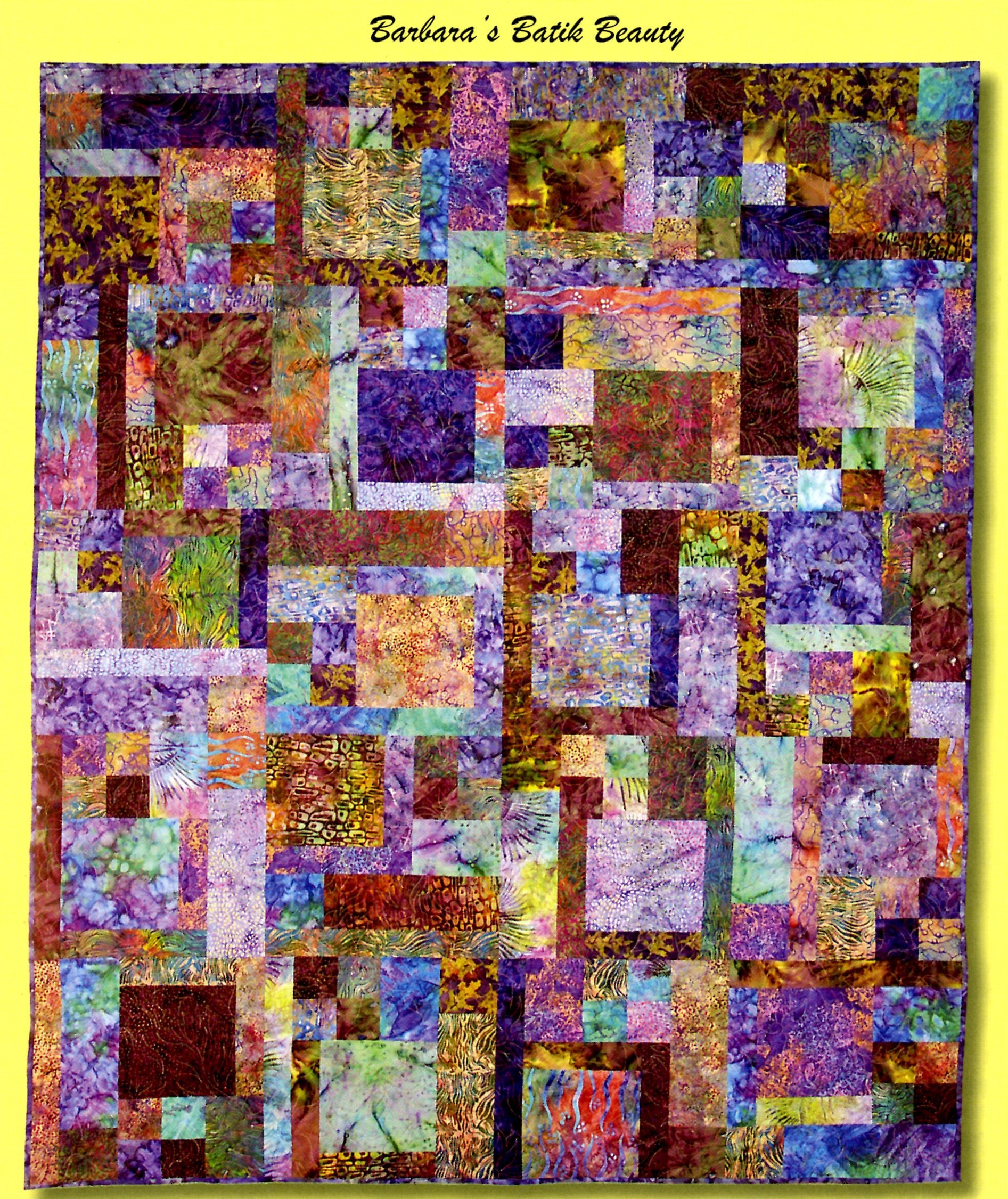 A colorful patchwork quilt featuring a variety of batik fabrics in purple, pink, green, yellow, and brown tones, with a yellow border and the text 'Barbara's Batik Beauty' at the top.