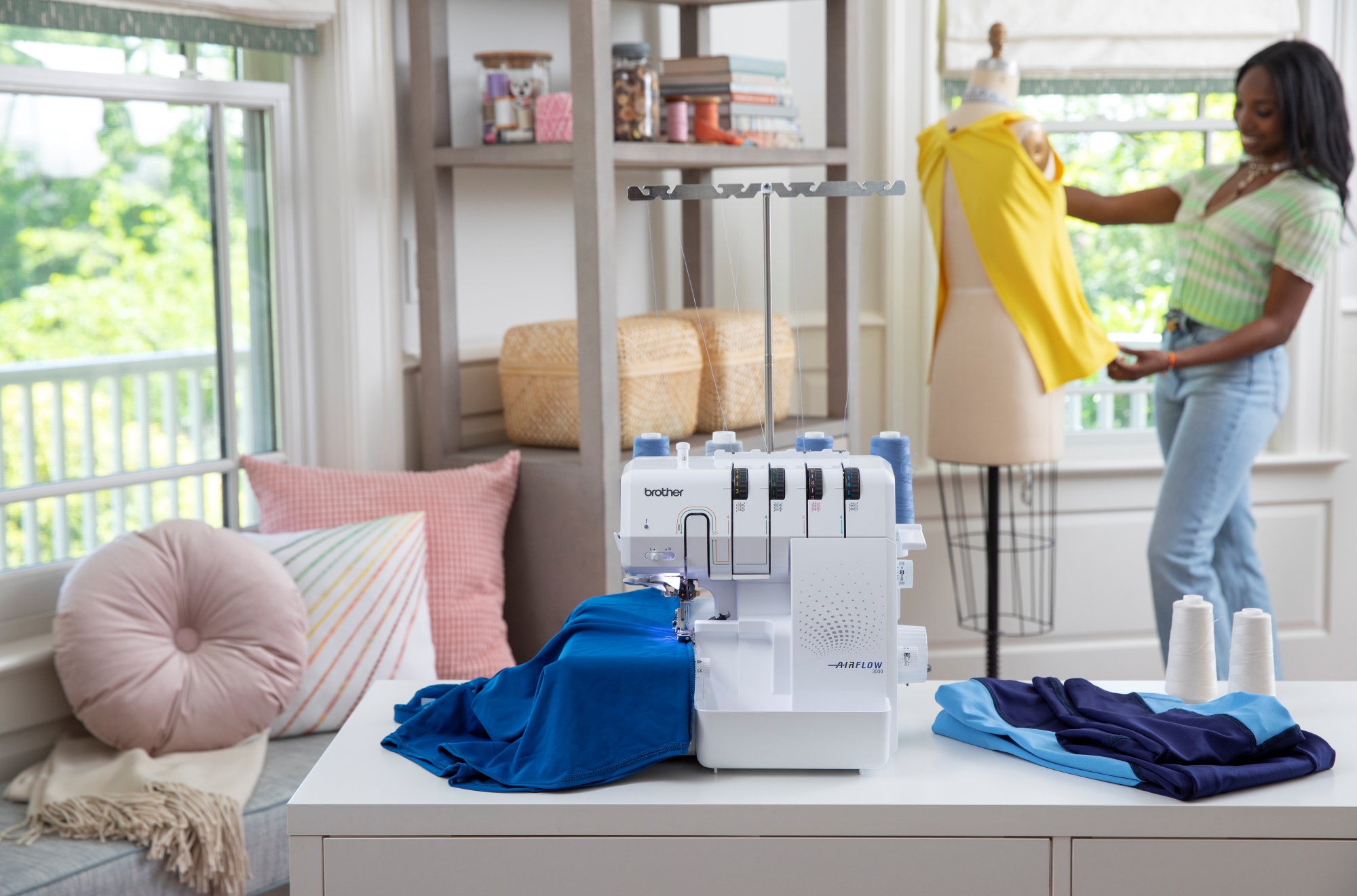 image of the Brother AIRFLOW 3000 Air Serger with sewing example and a woman in the background