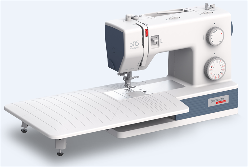 angled image of the Bernette b05 Academy Sewing Machine with extended table attached