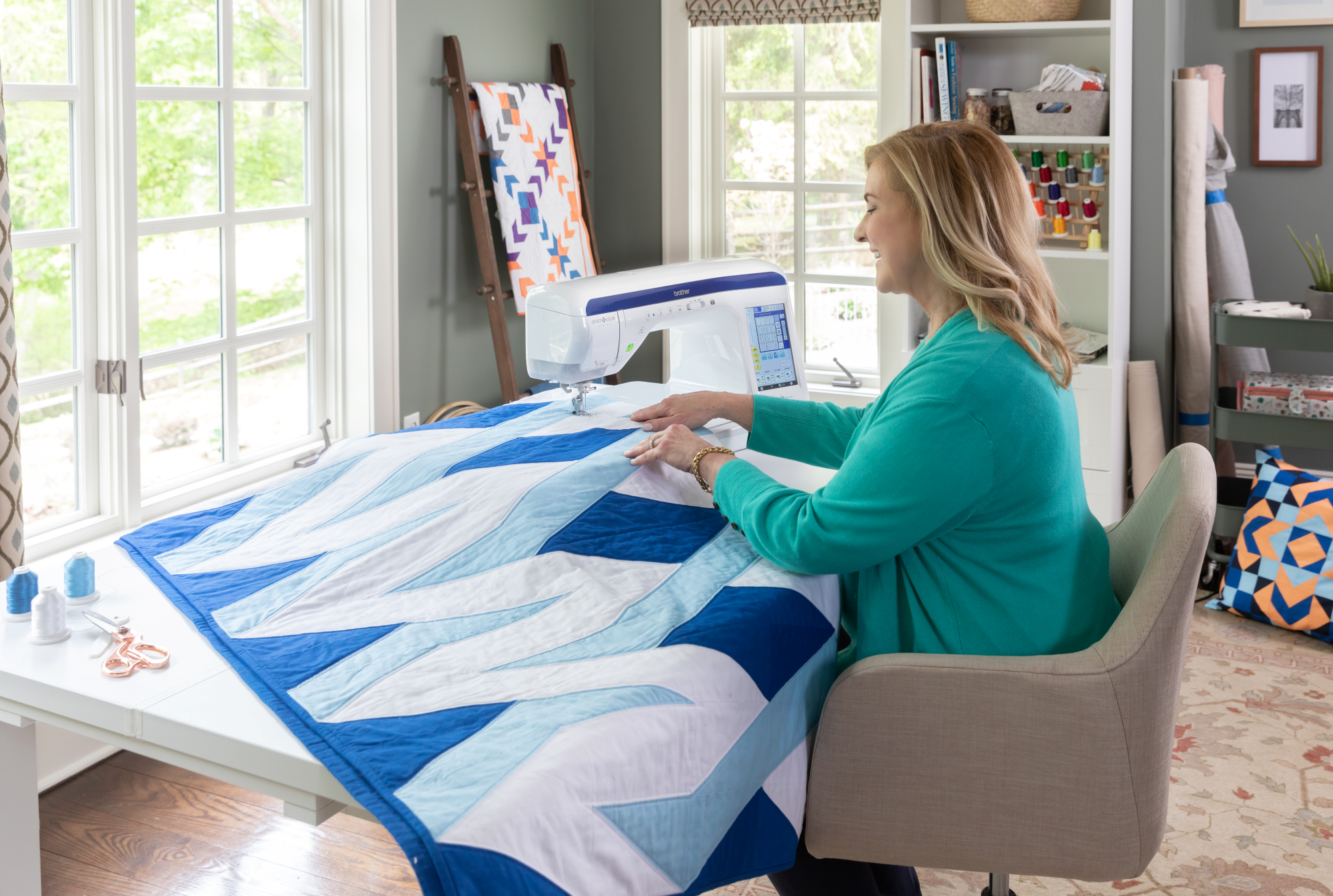 image of a woman using the Brother Innov-is BQ3100 eleven and a quarter inch Sewing and Quilting Machine to sew a quilt