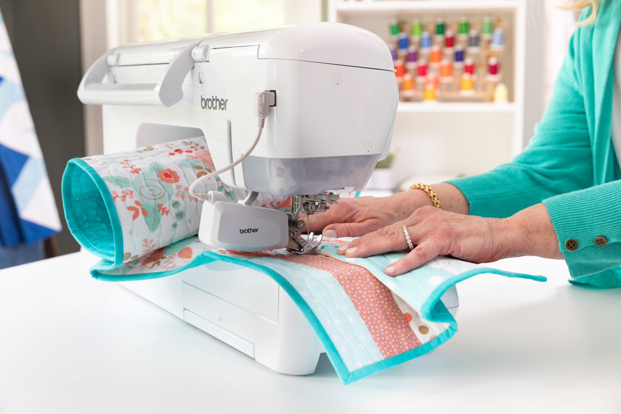 image of a woman using the Brother Innov-is BQ3100 eleven and a quarter inch Sewing and Quilting Machine to sew