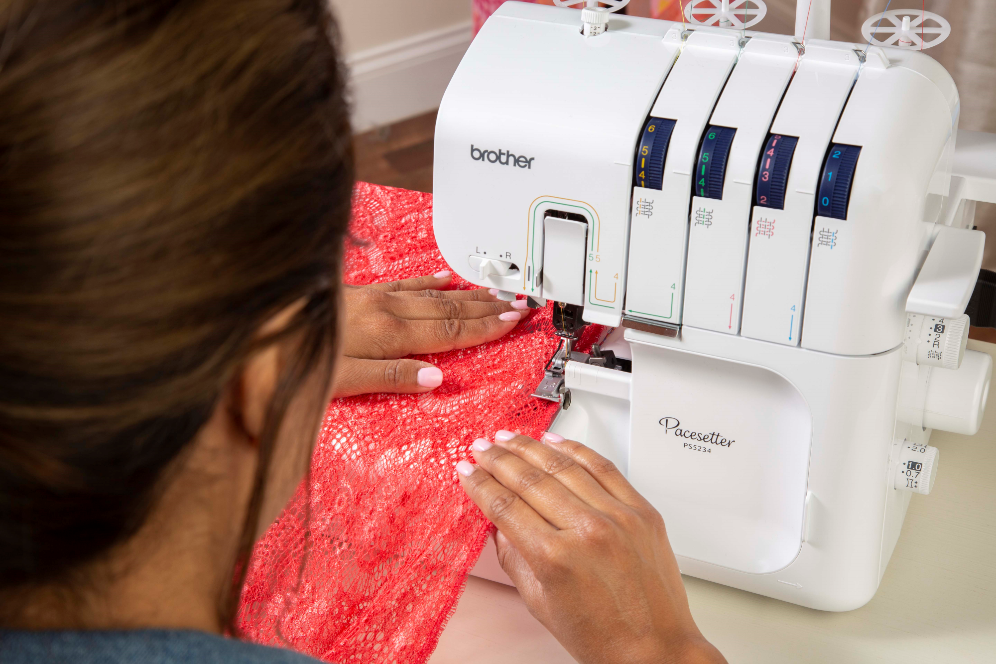 image of a woman using the Brother R Pacesetter PS5234 Serger Sewing Machine to sew an item