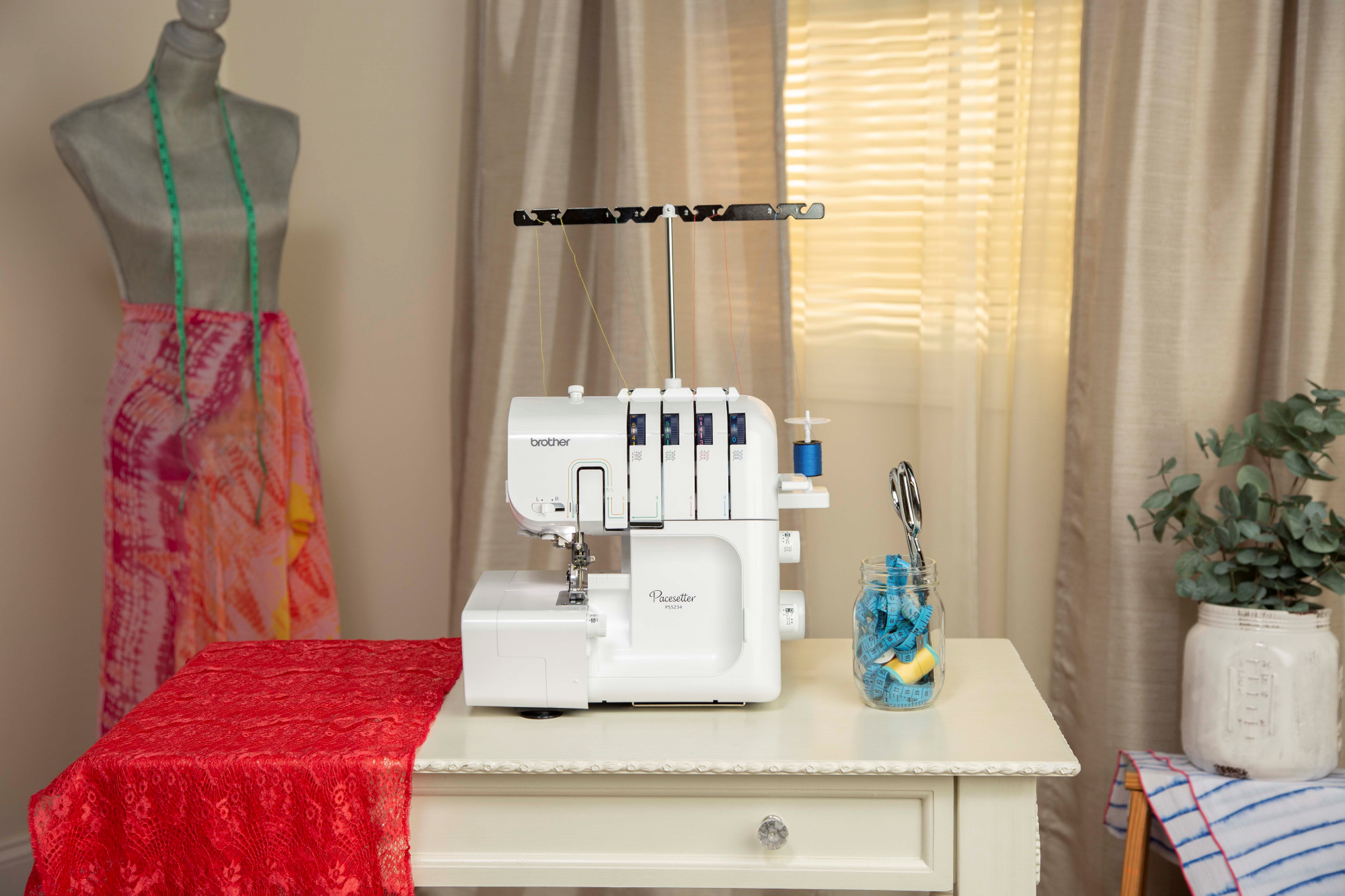 image of the Brother R Pacesetter PS5234 Serger Sewing Machine on a table with sewing supplies