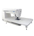 angled image of the JUKI HZL-NX7 Kirei Professional Quality Sewing and Quilting Machine with a table