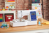 image of the Brother Innov-is NS1750D Sewing and Embroidery Machine 4x4 on a table with sewing supplies
