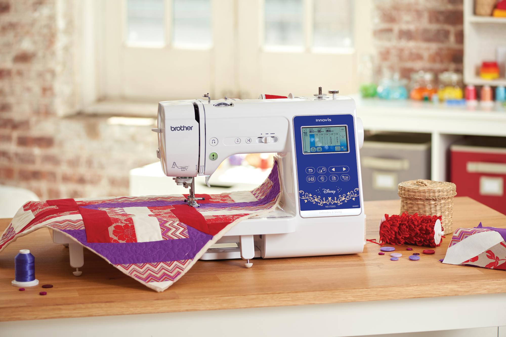 image of the Brother Innov-is NS1750D Sewing and Embroidery Machine 4x4 being used to quilt a quilt on a table with quilting supplies