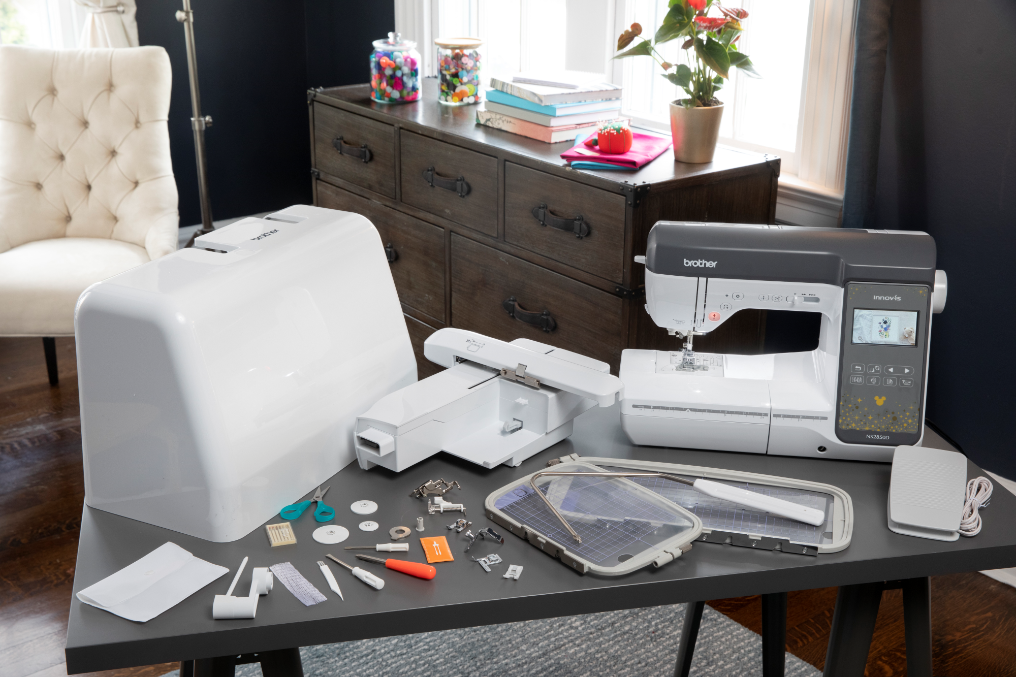 image of the Brother Innov-is NS2850D seven by five Sewing and Embroidery Machine on a table with sewing supplies and accessories