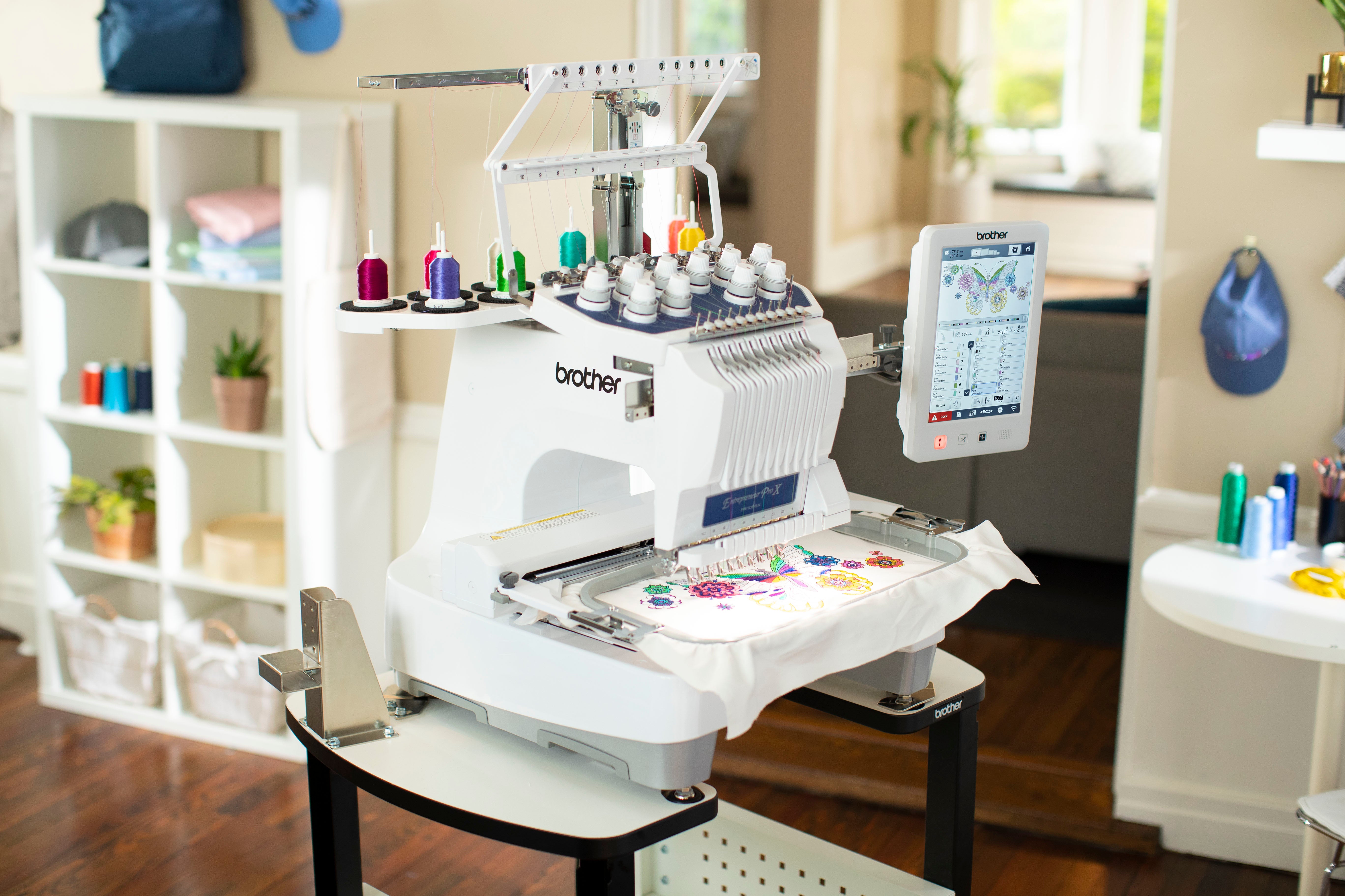Image of the Brother Entrepreneur Pro X PR1055X fourteen by eight ten needle embroidery machine in a room with example embroidery