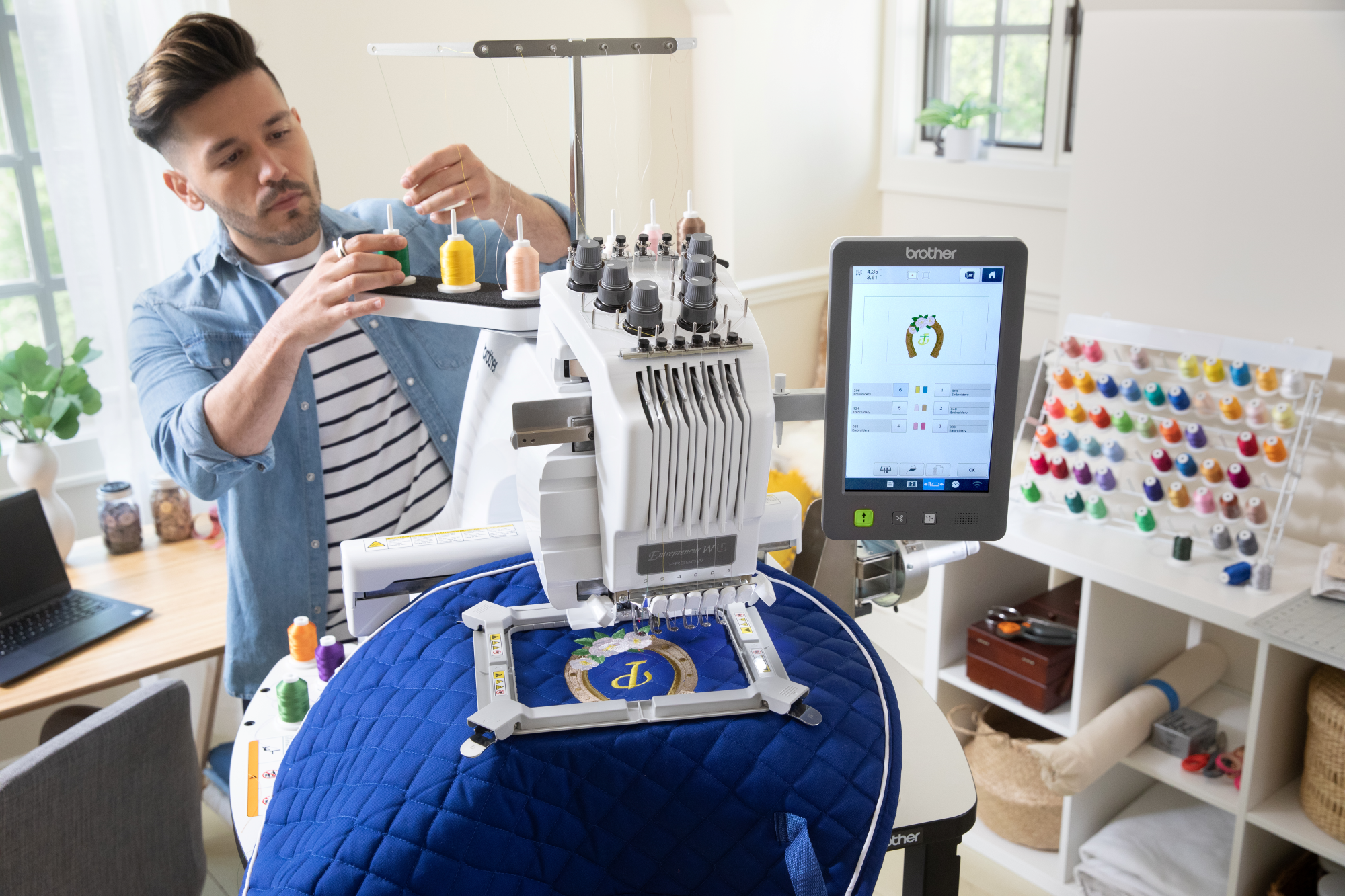 an image of a man using the Brother Entrepeneur W PR680W twelve by eight six needle embroidery machine to embroider an item showing off the magnetic frame