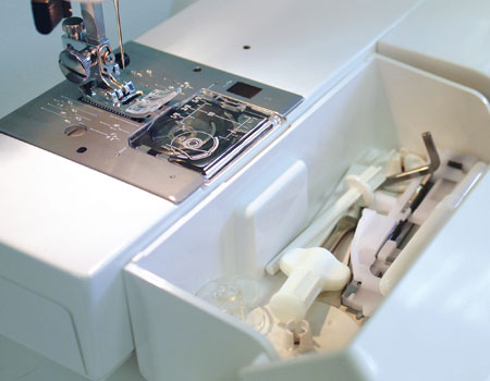 close up image of the Janome HD5000 Sewing and Quilting Machine accessory storage